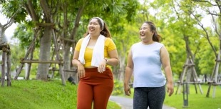 Two people with obesity take a walk in the park
